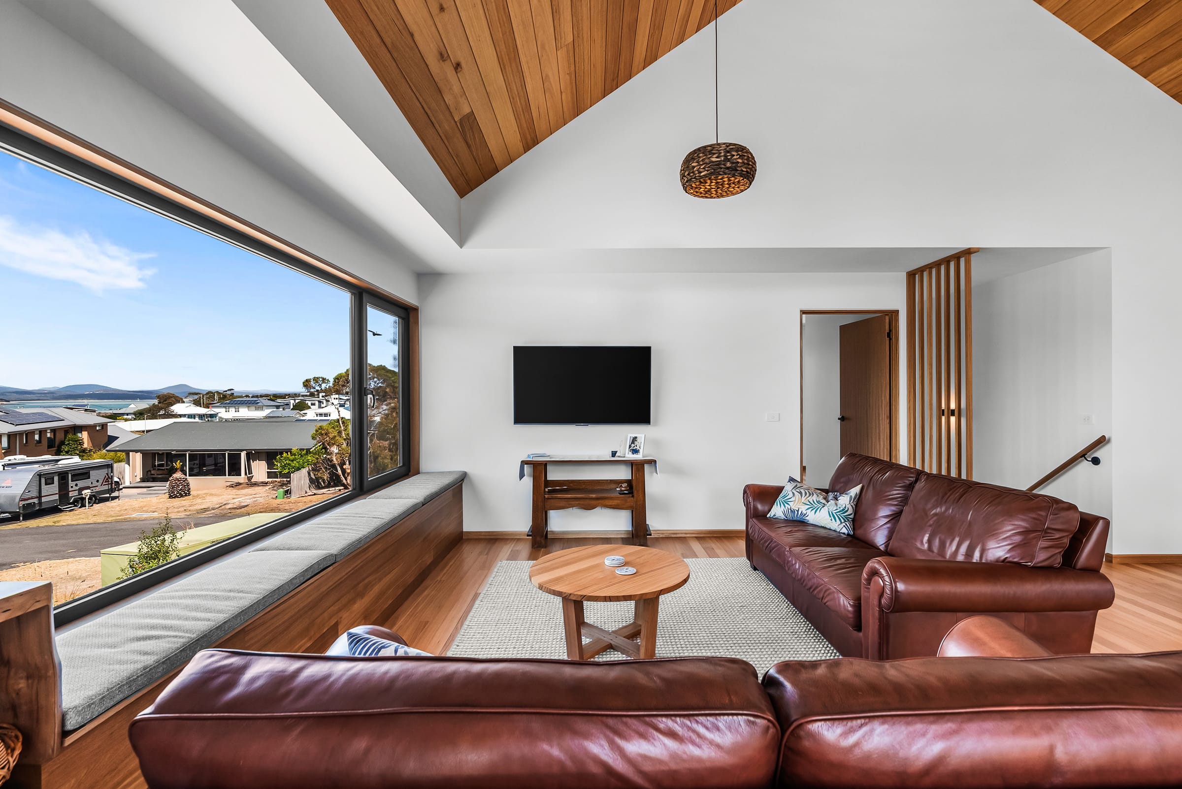 Living room with raked timber ceiling at Hawley