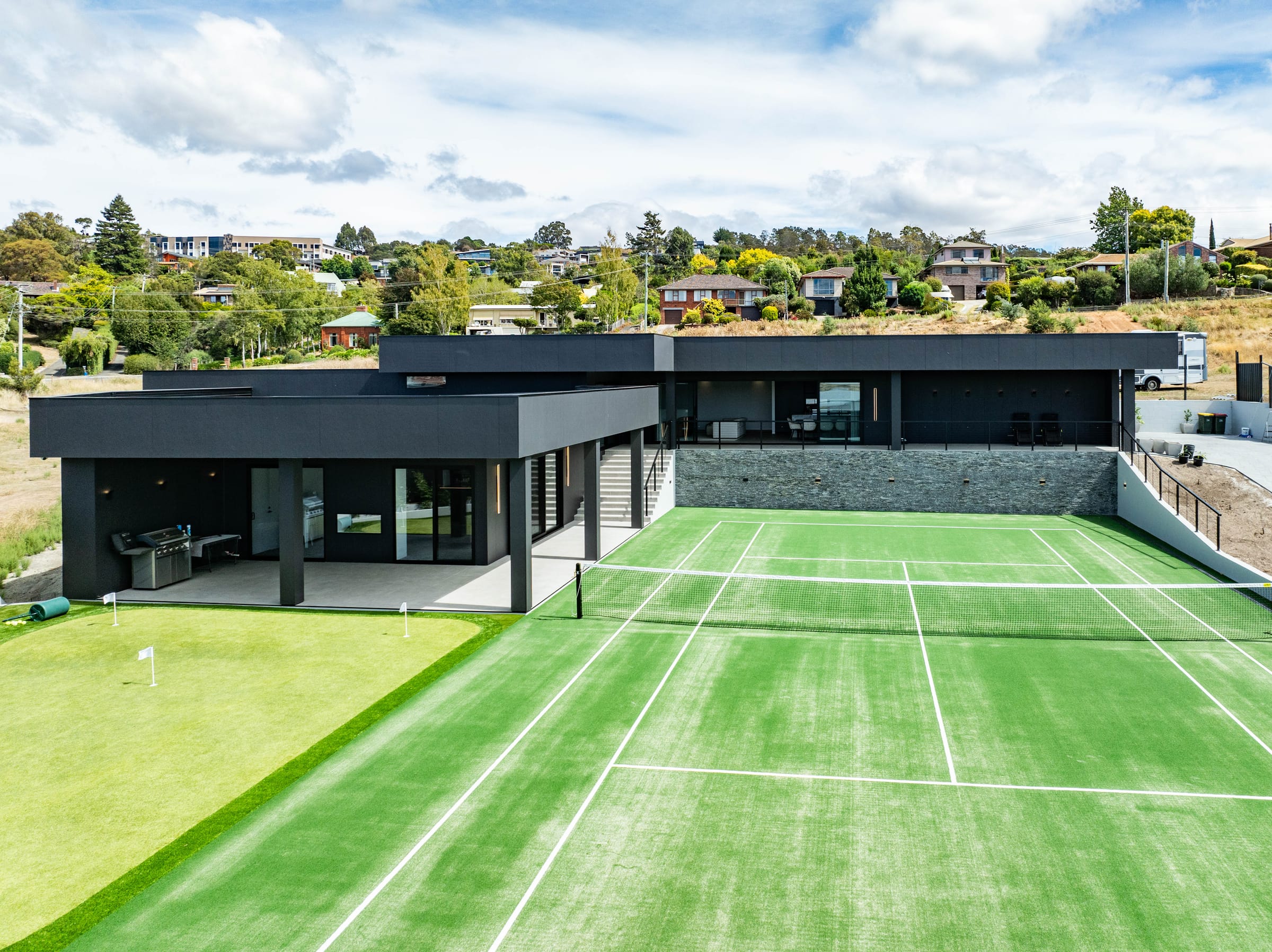 Aerial view of NIII, a Launceston home with a full tennis court
